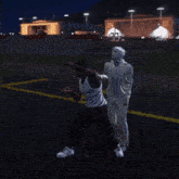 two men are standing in a parking lot with their hands on their heads