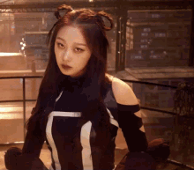 a woman wearing a black and white striped top with the letter t on the front