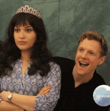 a woman wearing a tiara stands next to a man