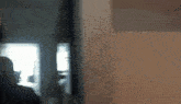 a blurry picture of a person standing in front of a mirror