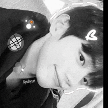a black and white photo of a young man with the name kyuhyun on his chest