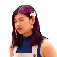 a woman with purple hair has a white flower in her hair .