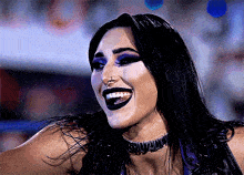 a woman wearing a choker that says ' shawn ' on it smiles