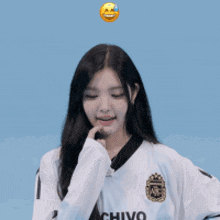 a girl wearing a white shirt that says chivo on the front
