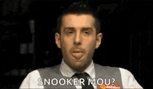 a man in a suit and tie is sticking his tongue out and saying snooker mou ?
