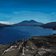 a lake with mountains in the background and a blue sky
