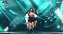 a group of women are dancing on a stage and the words honeycam.org are on the bottom of the screen