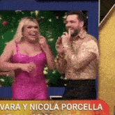 a woman in a pink dress and a man in a gold shirt are on a television show .