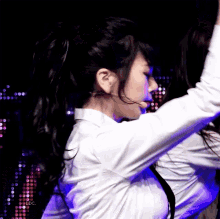 a woman in a white shirt is dancing in front of a purple background that says ldc on it