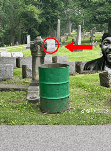 a green barrel in a cemetery with a red arrow pointing to a grave that says mustard