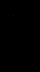 a man with a pie in front of his face in a dark room