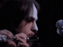a close up of a person playing a flute