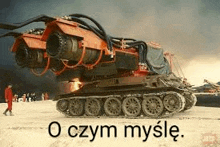 a large tank is sitting on top of a snowy field .