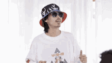 a man wearing a one piece shirt and a bucket hat