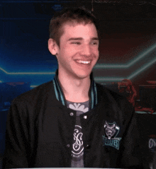a man wearing a black jacket that says the wolves