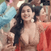 a woman in a very revealing top is dancing in a crowd of people .