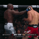 two fighters are fighting in a ufc ring and the ufc scoreboard shows that the winner is roundtree jr