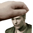 a pixelated image of a man 's head with a hand on it .