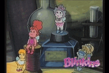 a bunch of blinkins dolls sitting around a bottle