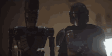 two robots are standing next to each other in a dark room and talking to each other .