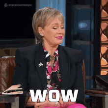 a woman sitting in a chair with the word wow written on her face
