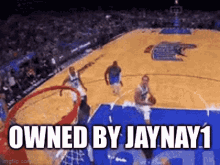 a basketball player is dunking the ball on a basketball court .