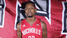 a basketball player wearing a red jersey that says nicholls on it
