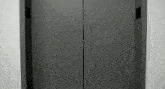 a close up of a black elevator door with the number 0 on it .