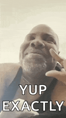 a man with a beard is making a face and says yup exactly
