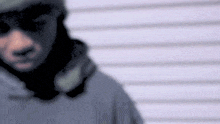 a blurry picture of a man wearing a mask and sunglasses .