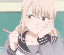 a girl with blonde hair is holding a pink pencil