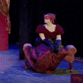 a woman in a red dress is sitting on a bench with the words fresh gossip written above her