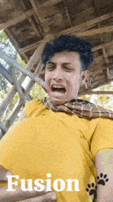 a man in a yellow shirt is making a funny face and the word fusion is on the bottom