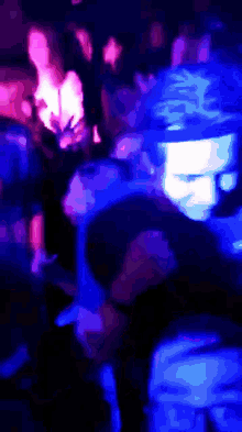a blurry photo of people dancing in a club