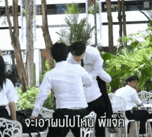 a man in a white shirt is fighting another man in a black shirt