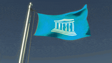 a blue flag with the word unesco written on it