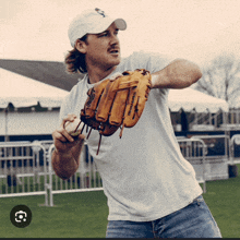 a man wearing a white shirt and a texas rangers hat is holding a baseball and a catcher 's mitt