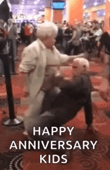 a man and a woman are dancing in a crowded room in a casino .