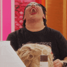 a woman wearing a black t-shirt that says princess is laughing