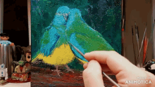 a person is painting a picture of two birds with the words made in animotica on the bottom right