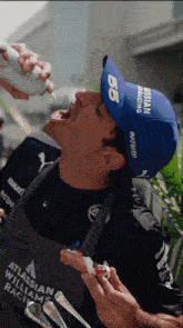 a man wearing a hat that says nissan racing on it