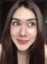 a close up of a woman 's face with a slight smile on her face