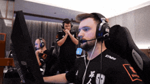 a man wearing headphones with the word syner on his shirt