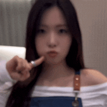 a woman is pointing her finger at the camera .