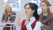 a girl sitting in a classroom with a sign that says sounds fun