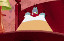 a cartoon character is laying on a bed with a red blanket