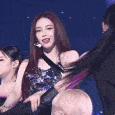 a woman with red hair is dancing on stage