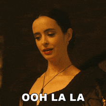 a woman in a black dress says " ooh lala "