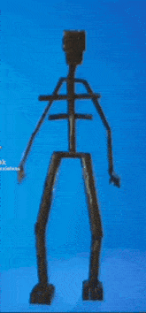 a skeleton made out of wood is standing on a blue background