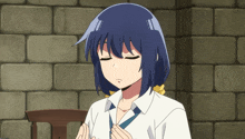 a girl with blue hair and a white shirt is praying with her eyes closed